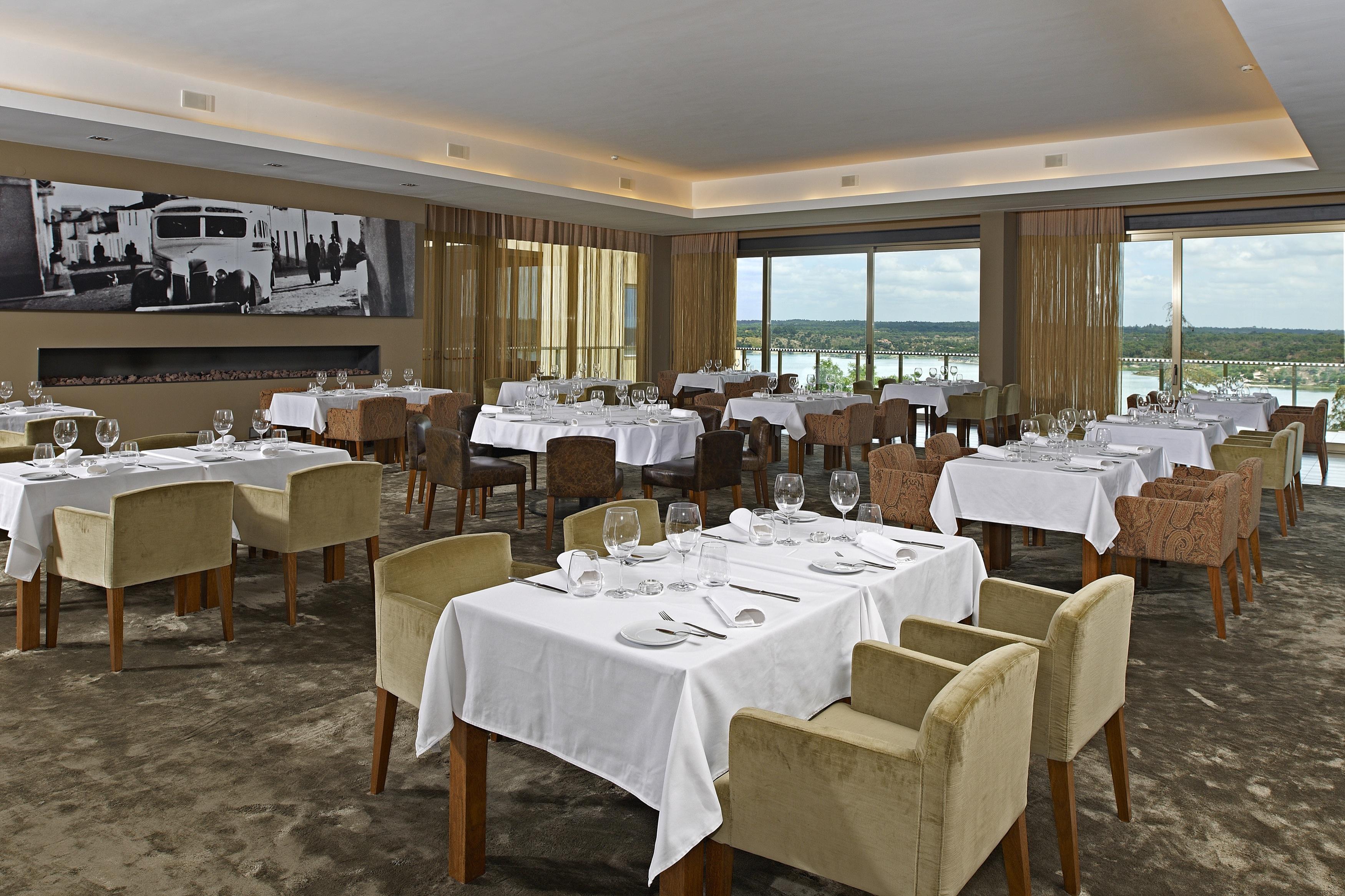 拉戈芒塔格别墅瑙酒店 蒙塔吉尔 外观 照片 The photo shows an elegant restaurant interior featuring neatly arranged tables with white tablecloths. Each table is set with plates, cutlery, and glasses. The seating includes a mix of upholstered chairs in different colors—some light and others da